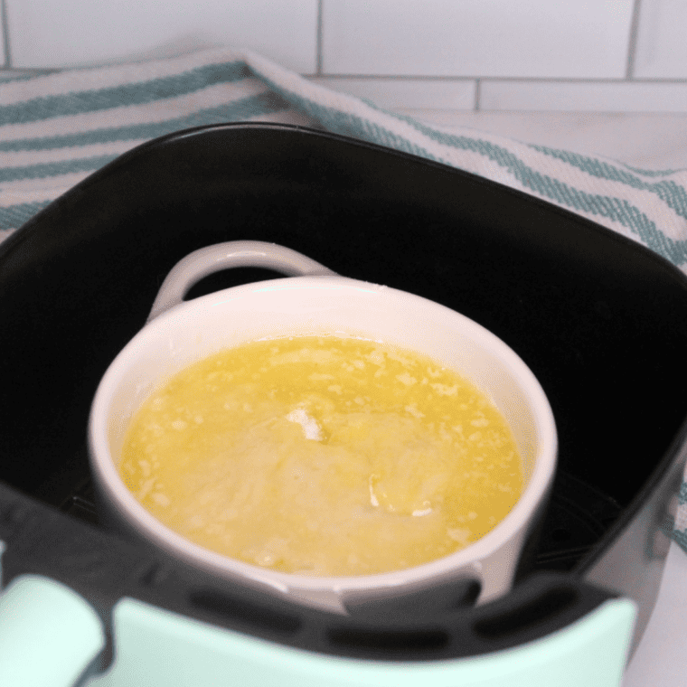 Air fryer lemon dump cake baking at 310 degrees until golden brown and set.