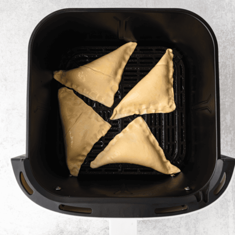 "Placing lemon turnovers in the air fryer basket."