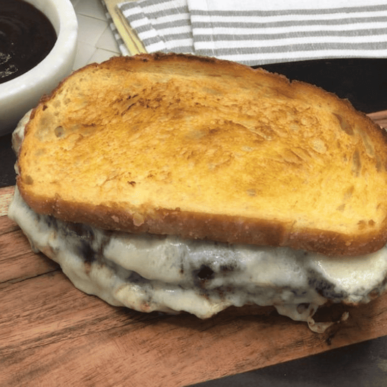 "Close-up of an Air Fryer Meatloaf Sandwich with layers of meatloaf and melted cheese."