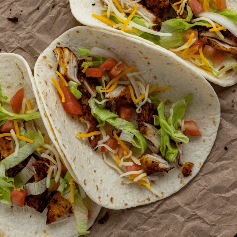Close-up of air fryer chicken street tacos with juicy seasoned chicken and fresh toppings
