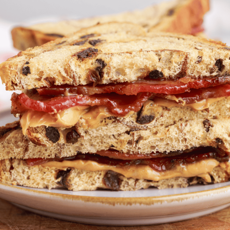 A crispy Air Fryer Peanut Butter and Bacon Sandwich served on a plate, featuring layers of peanut butter, honey, and caramelized bacon.