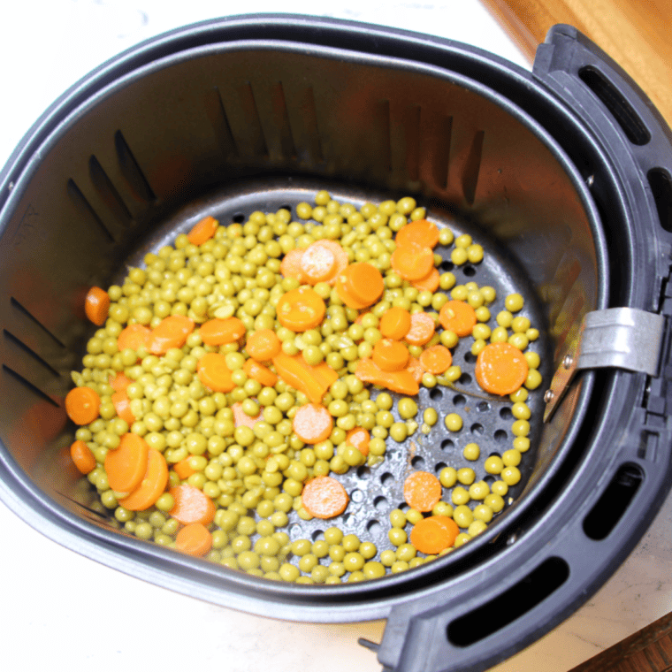 "Fresh peas and carrots cooked in an air fryer"