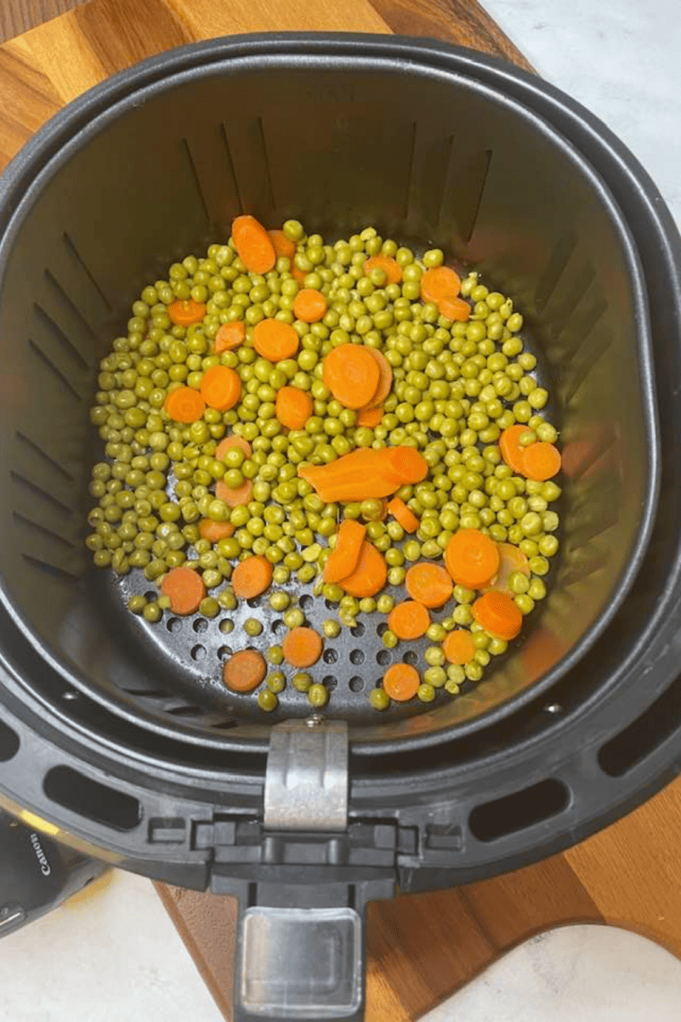 "Air fryer peas and carrots served in a bowl"