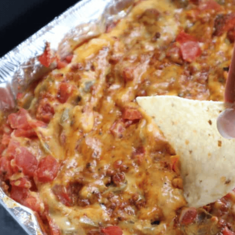 Air Fryer Queso cooking in the air fryer, bubbling and melted.