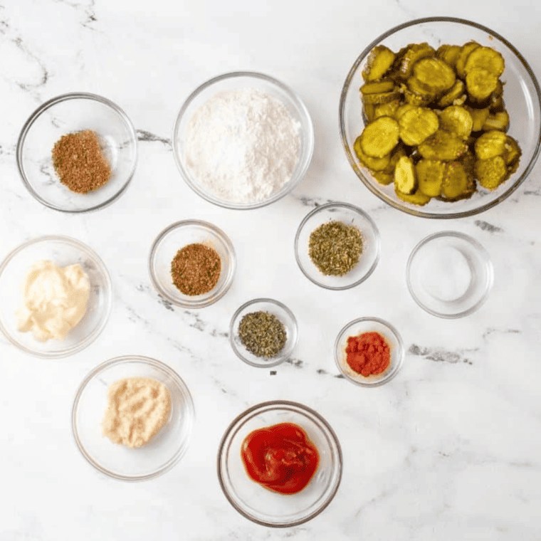Mayonnaise, ketchup, pickle juice, Dijon, and spices laid out for fried pickle sauce