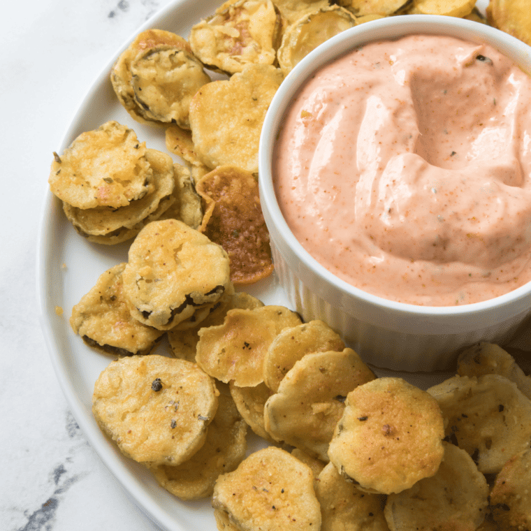 Bowl of homemade fried pickle dipping sauce garnished with paprika