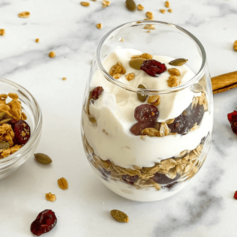 Air Fryer Vanilla Granola in a parfait glass with fruit and dried fruit