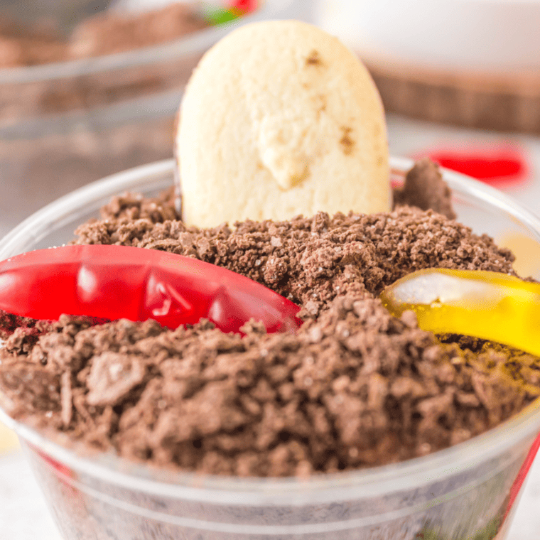 Layered Dirt Cup dessert with gummy worms on top
