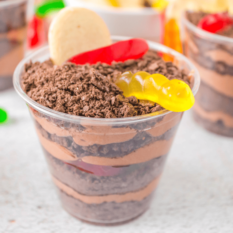 Dirt Cups served in clear cups with chocolate pudding, Oreo crumbles, and gummy worms