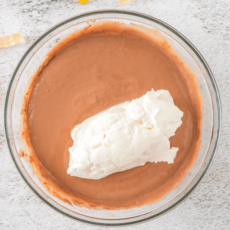 Adding crushed Oreos on top of the pudding layer