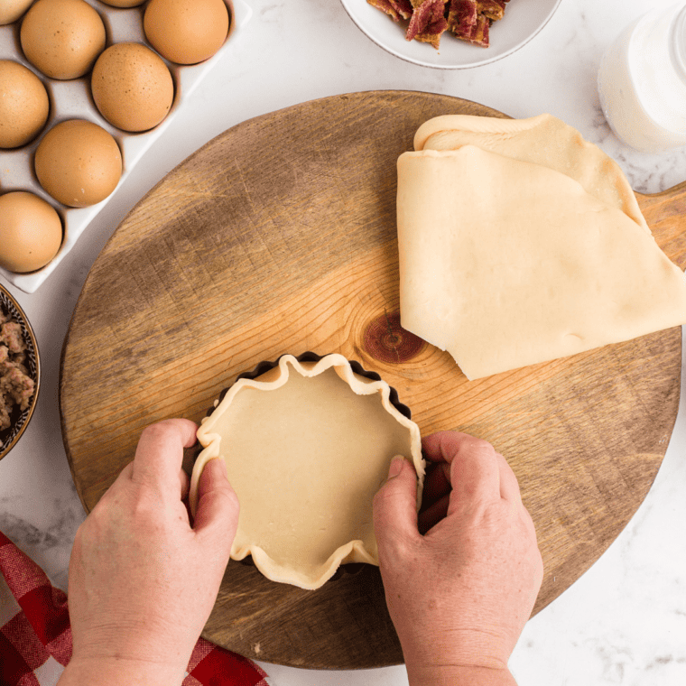 Cutting the pie crust out with the mold.