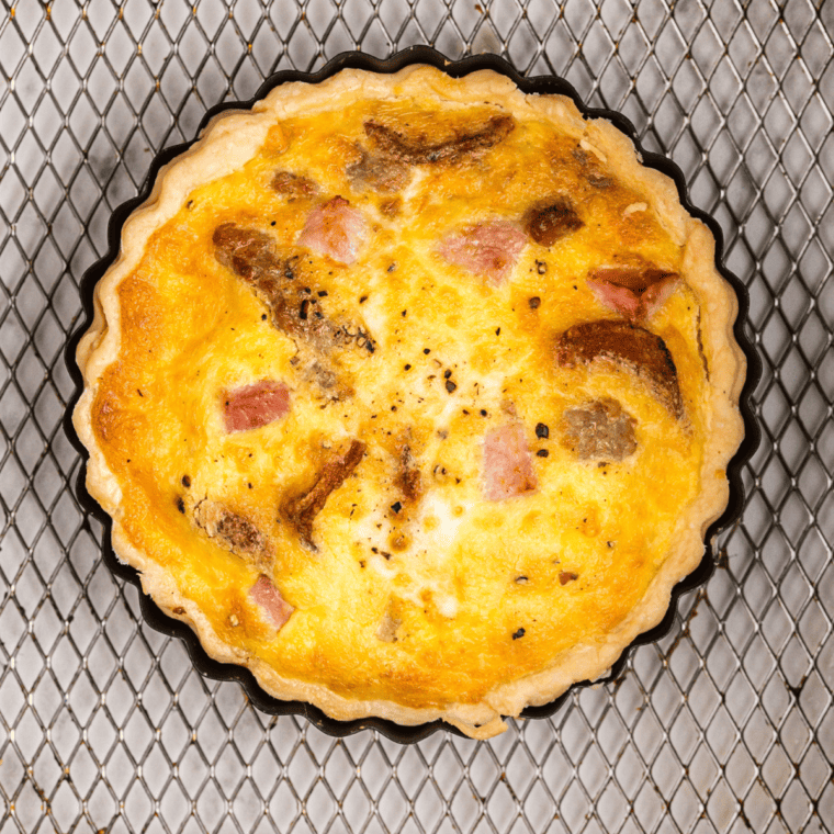 "Cooked Air Fryer Meat Lover’s Quiche in the air fryer basket, golden and ready to serve"