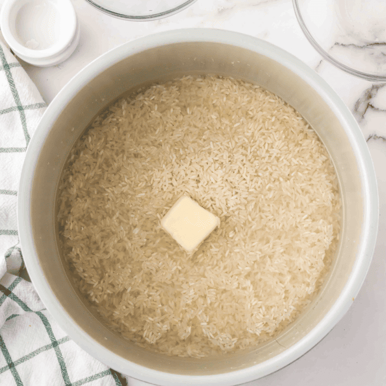 Rinsing Basmati rice under cold water to remove excess starch.