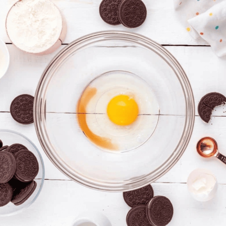 Whisking egg, milk, vanilla, and vegetable oil in a large bowl, air fryer preheating to 400°F.