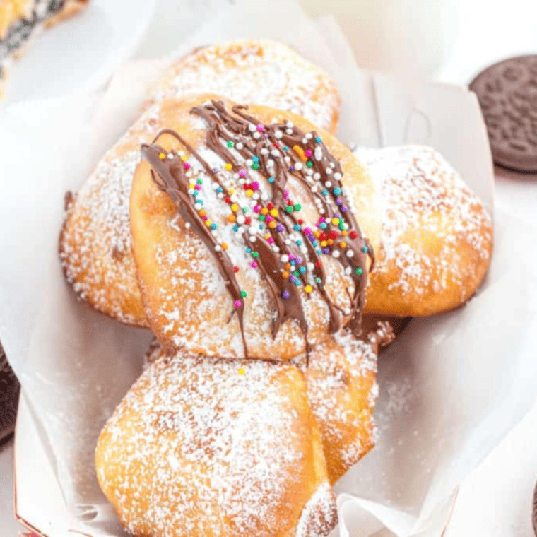 Air fried Oreos coated in pancake batter, golden and crispy, served on a plate.