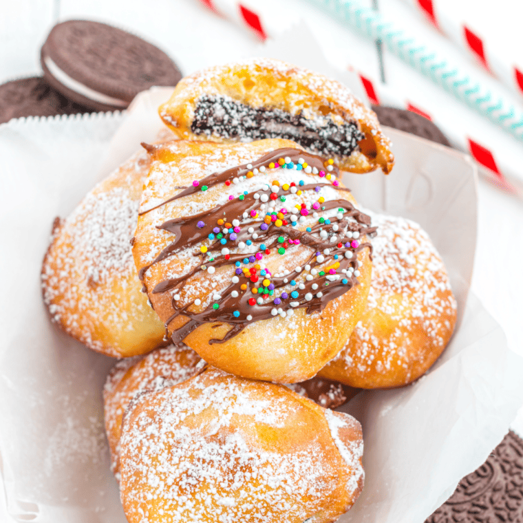 Golden air fried Oreos dipped in pancake batter served on a plate.