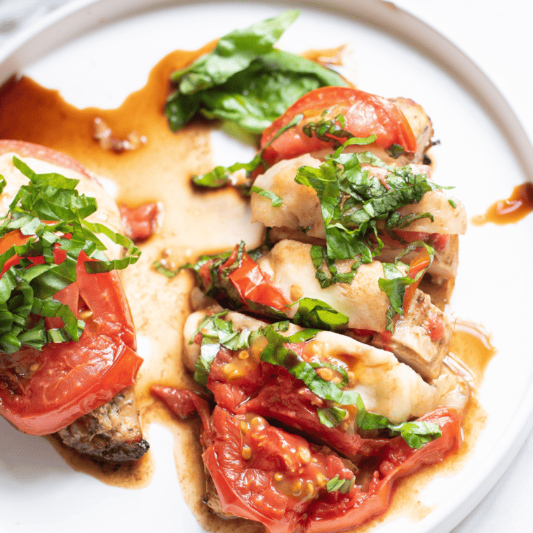 Air fryer caprese chicken served on a plate with a side salad