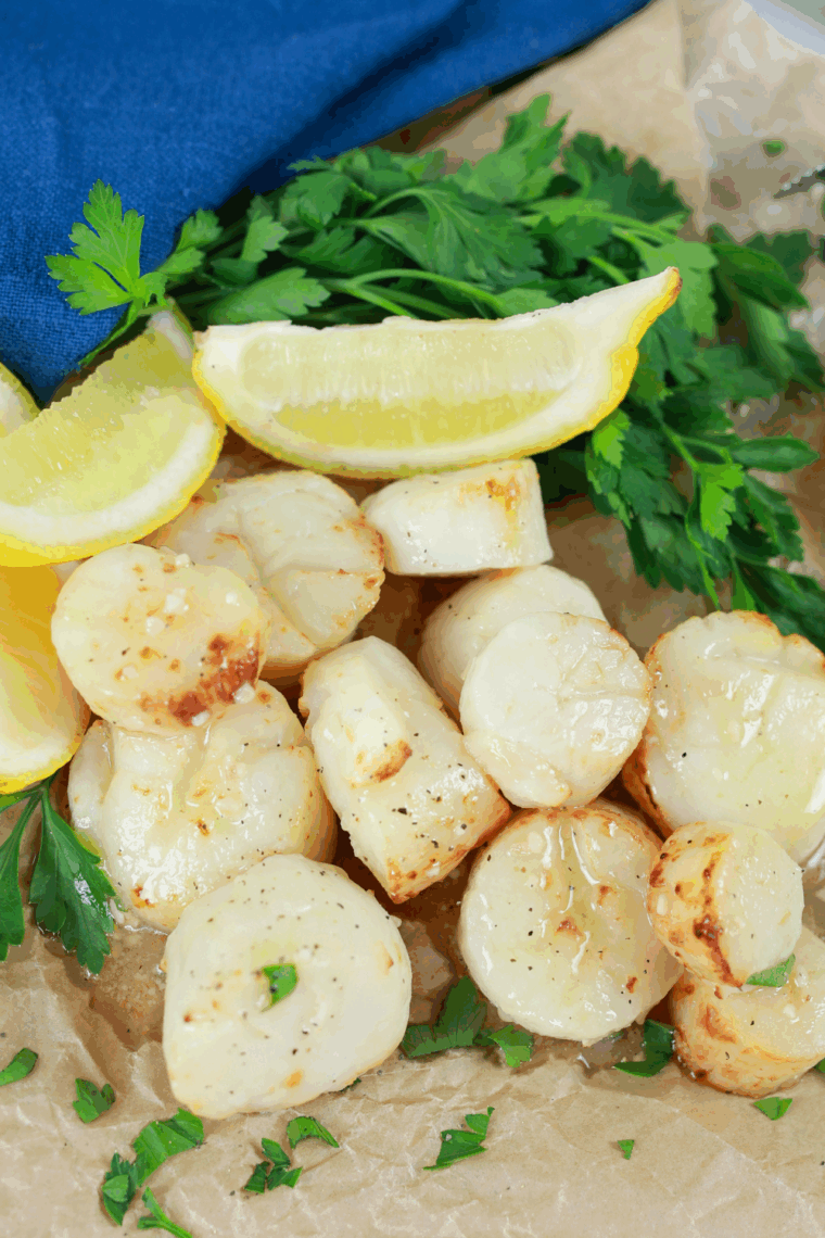 Plate of golden-brown air fryer AIP scallops garnished with fresh herbs