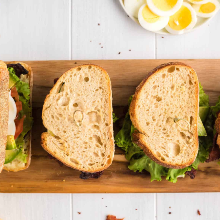 Close-up of a halved air fryer BLT showing crispy bacon and fresh tomato