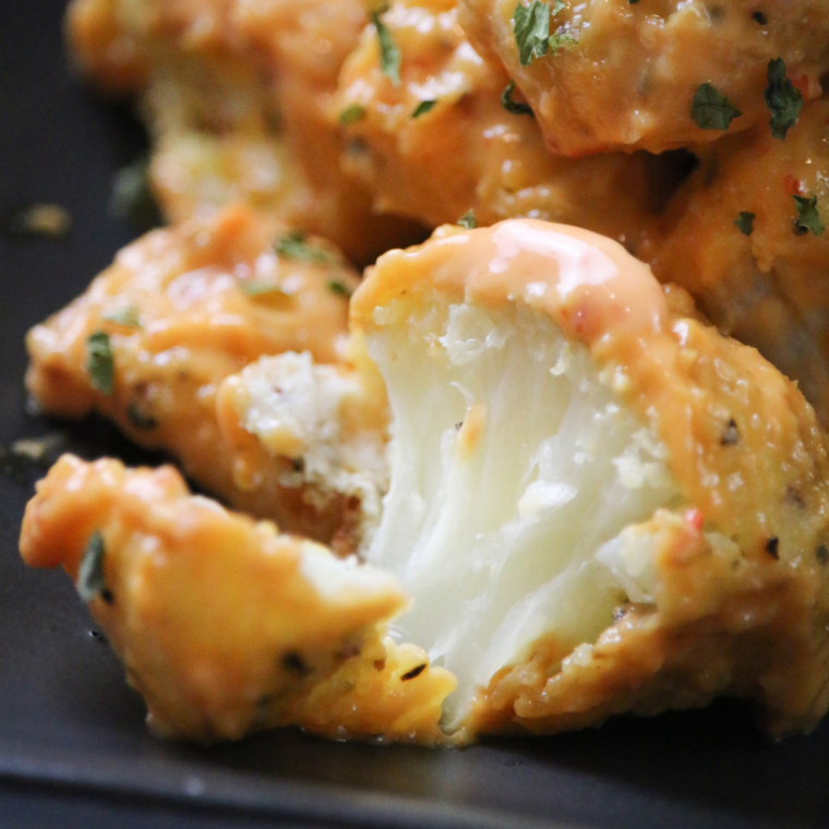 Crispy and golden-brown Air Fryer Bang Bang Cauliflower served with a creamy spicy sauce.