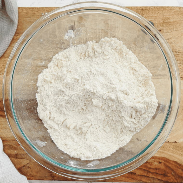 Whisking together flour, sugar, baking powder, and salt in a medium bowl