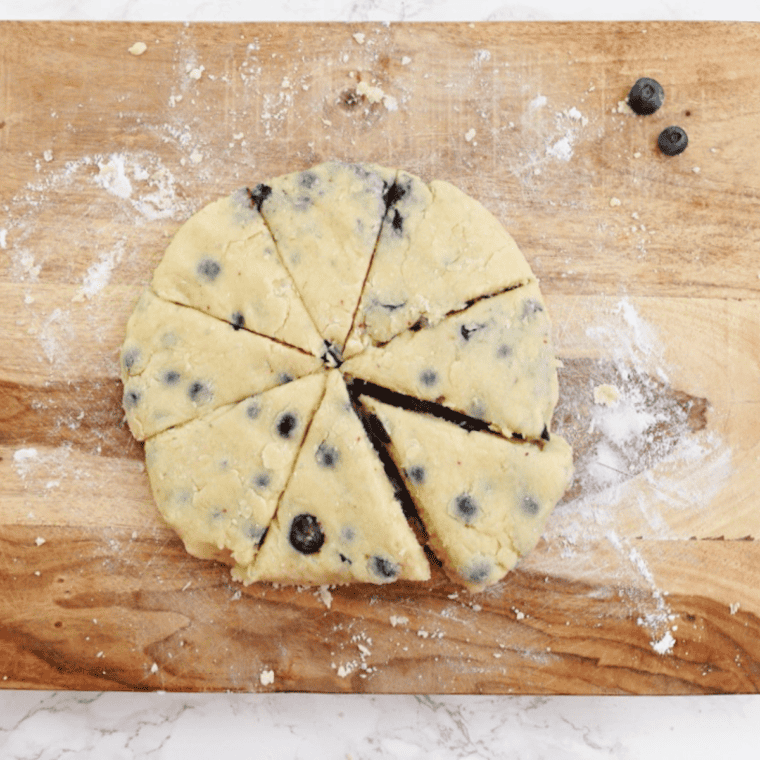 Placing scone wedges in the air fryer basket with space between each so they aren't touching