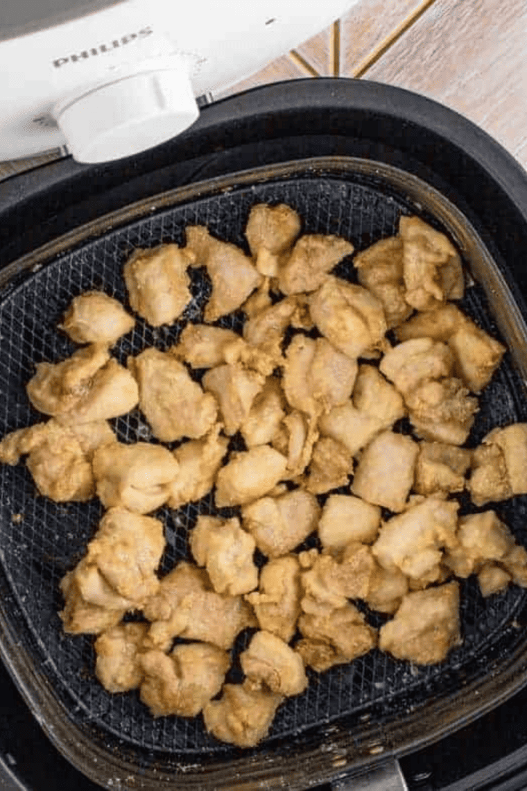 Close-up of crispy Air Fryer Ranch Chicken Bites garnished with herbs.