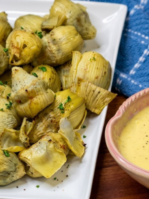 Canned artichoke hearts in the air fryer go from soft and watery to genuinely crispy in about 8 minutes — golden and craggy on the outside, tender and creamy in the middle. They're the kind of snack you make once and then keep a can in the pantry for permanently.