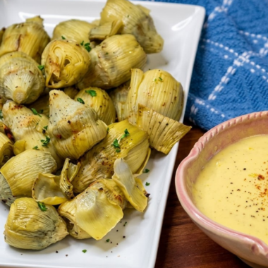 Canned artichoke hearts in the air fryer go from soft and watery to genuinely crispy in about 8 minutes — golden and craggy on the outside, tender and creamy in the middle. They're the kind of snack you make once and then keep a can in the pantry for permanently.