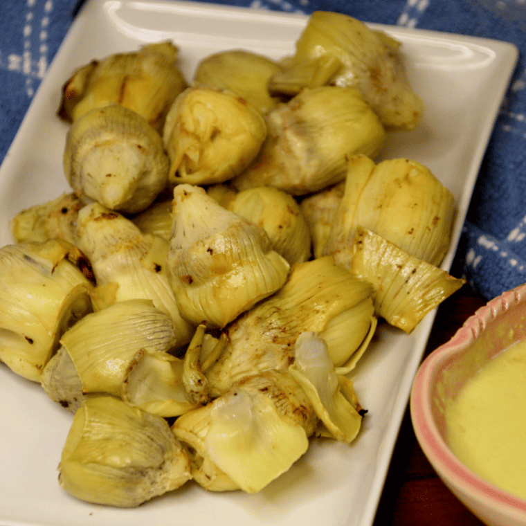 Close-up of crispy air fried artichokes showing golden edges and tender centers.
