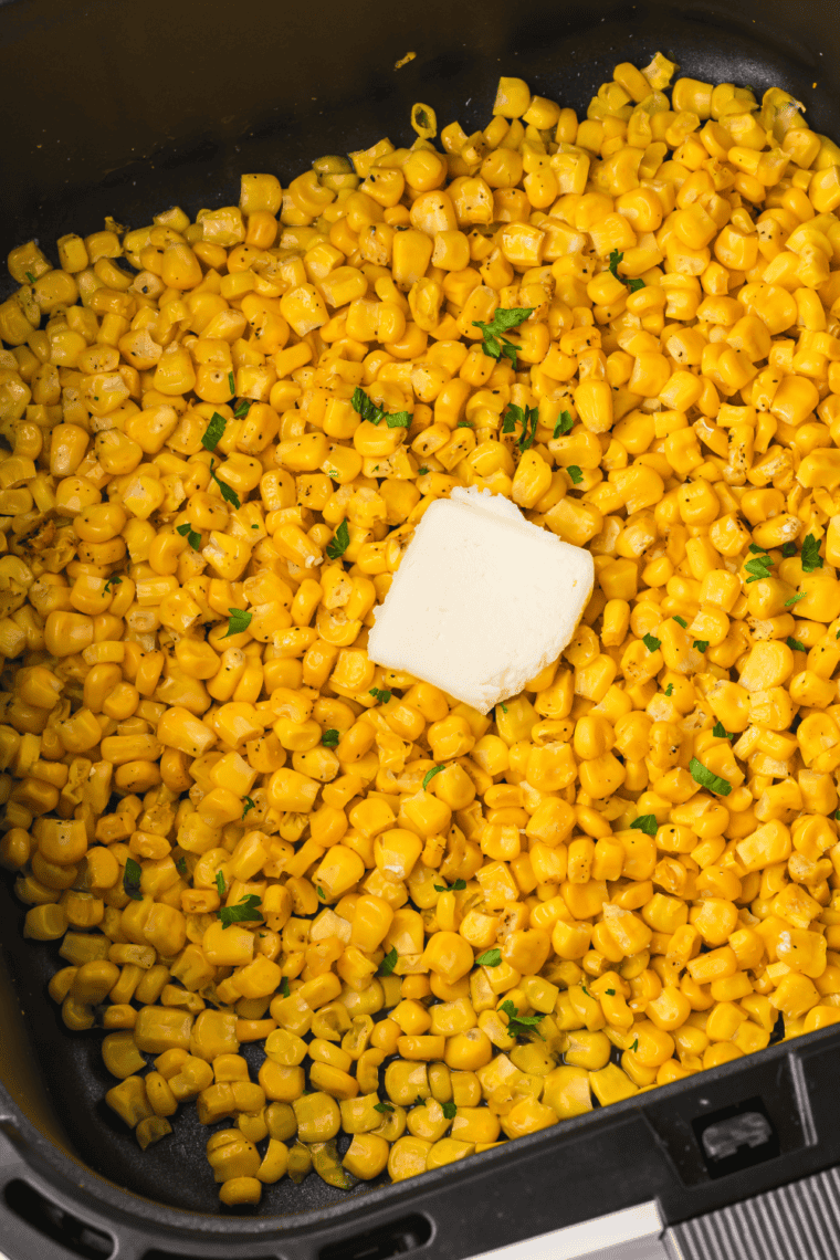 Air Fryer Canned Corn cooked to perfection, with a crispy golden finish and seasoned with butter, garlic powder, and pepper.