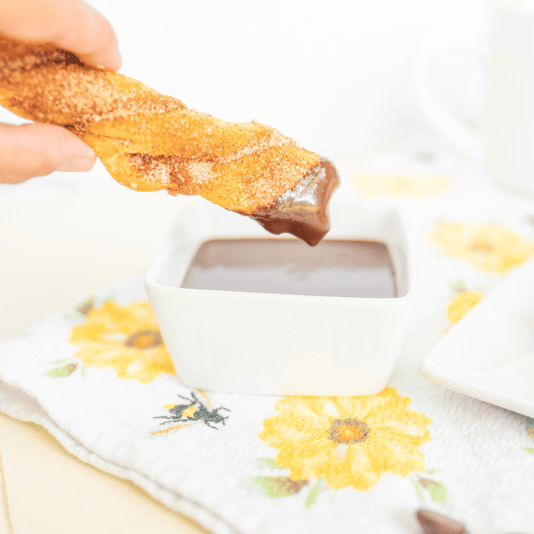 Close-up of crispy crescent roll churros with a side of chocolate dipping sauce