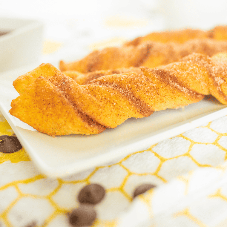 Twisted crescent dough churros showing the crispy golden-brown exterior