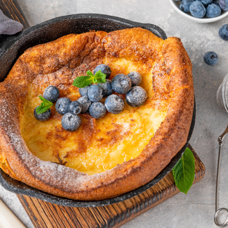 Puffy Dutch baby pancake rising in air fryer skillet