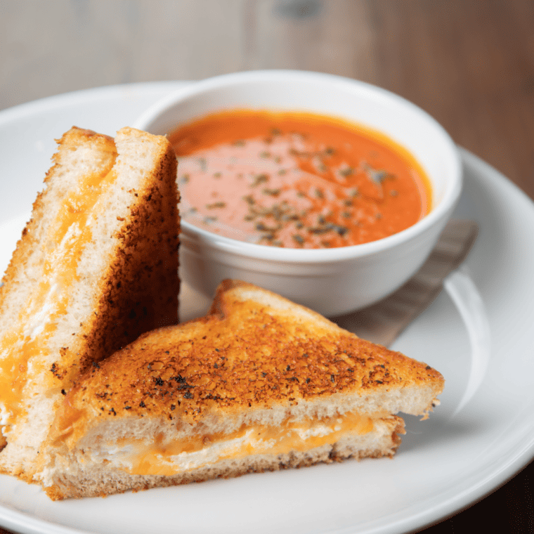 "Freshly made Air Fryer Feta, Tomato, and Basil Grilled Cheese, served with a side of tomato slices."