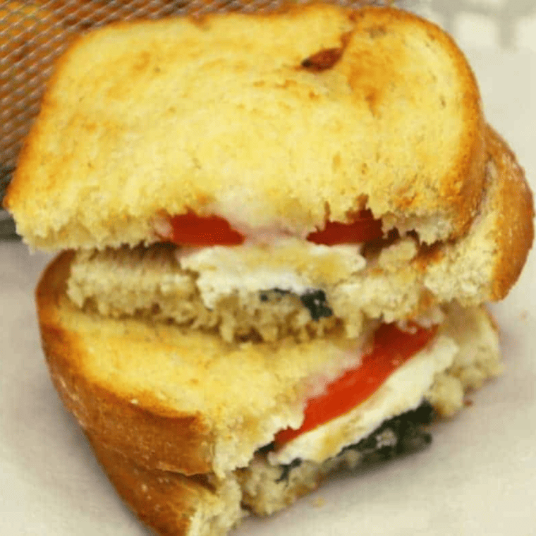 "Golden and crispy Air Fryer Feta, Tomato, and Basil Grilled Cheese sandwich with melty cheese."