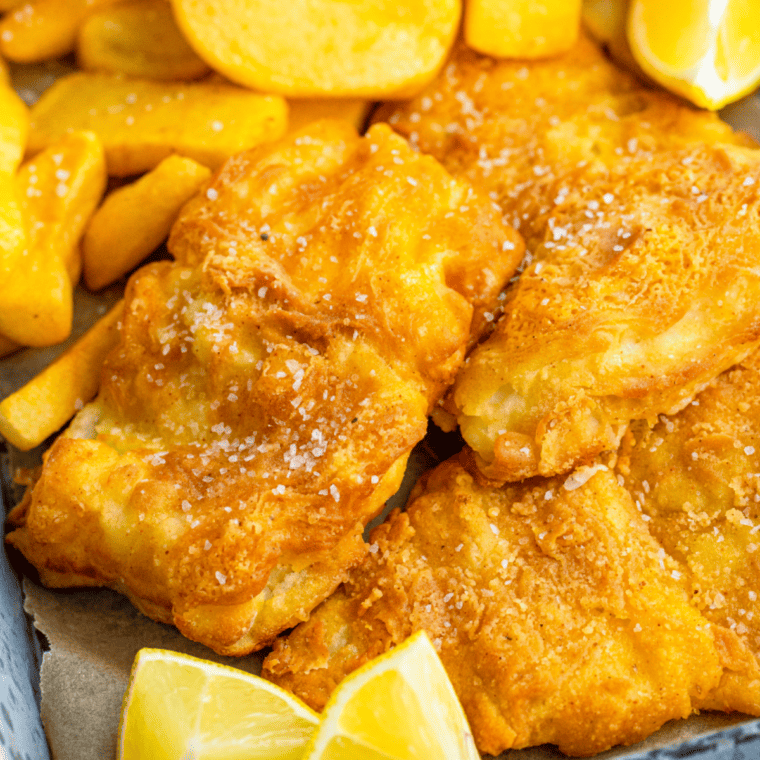 Golden baked fish fillets and crispy fries served with a bowl of creamy homemade tartar sauce.