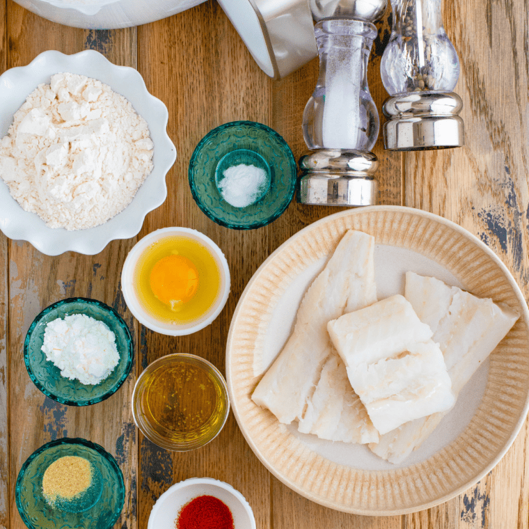 Ingredients needed for Healthy Fish and Chips With Homemade Tartar Sauce on kitchen table.