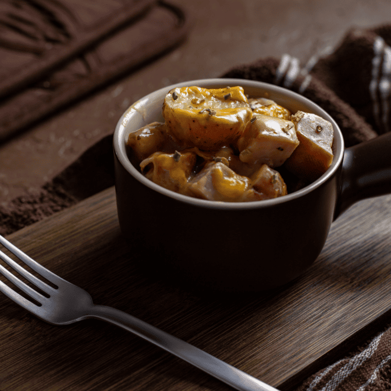 Close-up of creamy ham and potato casserole with bubbling cheese, cooked in the air fryer