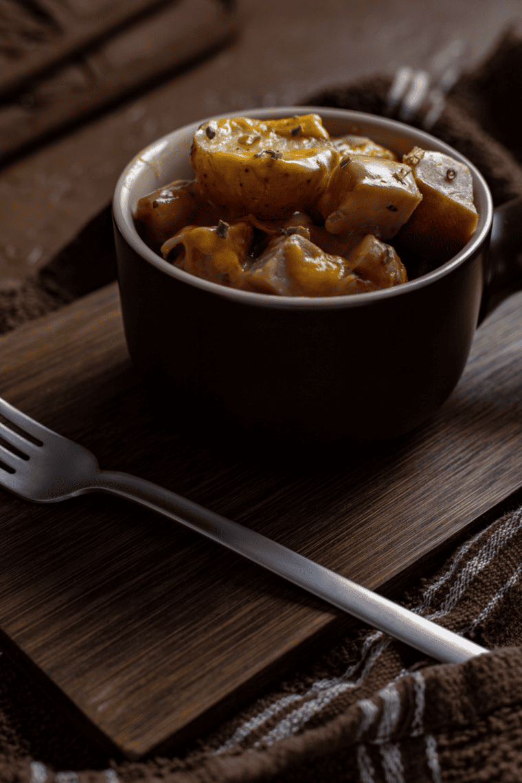 Serving of air fryer ham casserole on a plate showing tender potato layers and diced ham