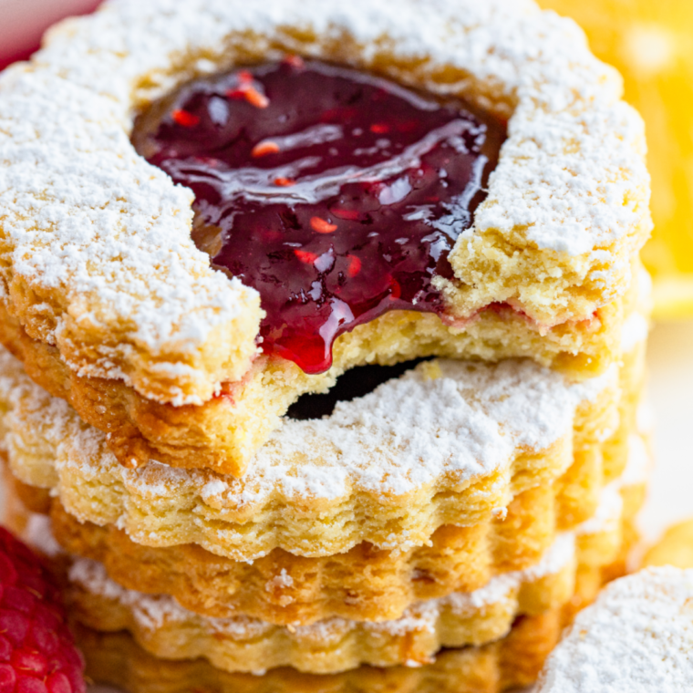 Air Fryer Linzer Cookies with raspberry preserves and powdered sugar dusting.