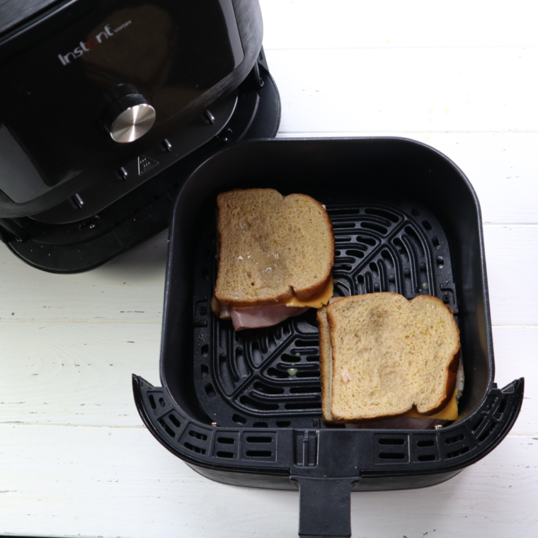 Air frying Monte Cristo sandwiches in greased basket until golden brown and melted