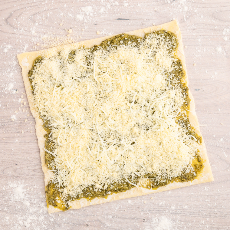 Adding the cheese on top of the puff pastry dough.