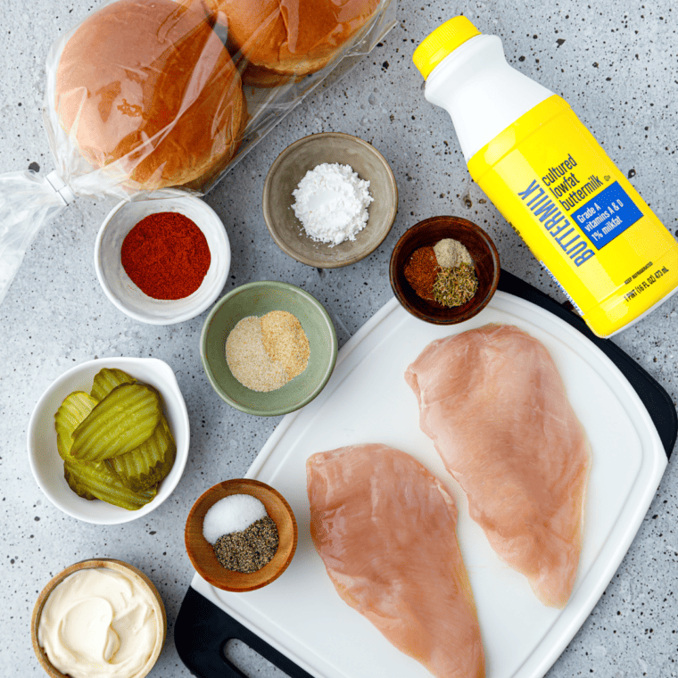 Ingredients needed for Air Fryer Popeyes Blackened Chicken Sandwiches on kitchen table.