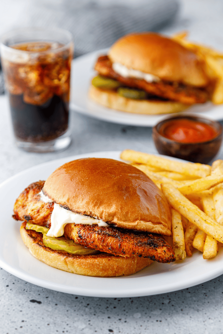 Air Fryer Popeyes Blackened Chicken Sandwich on a toasted bun with pickles.
