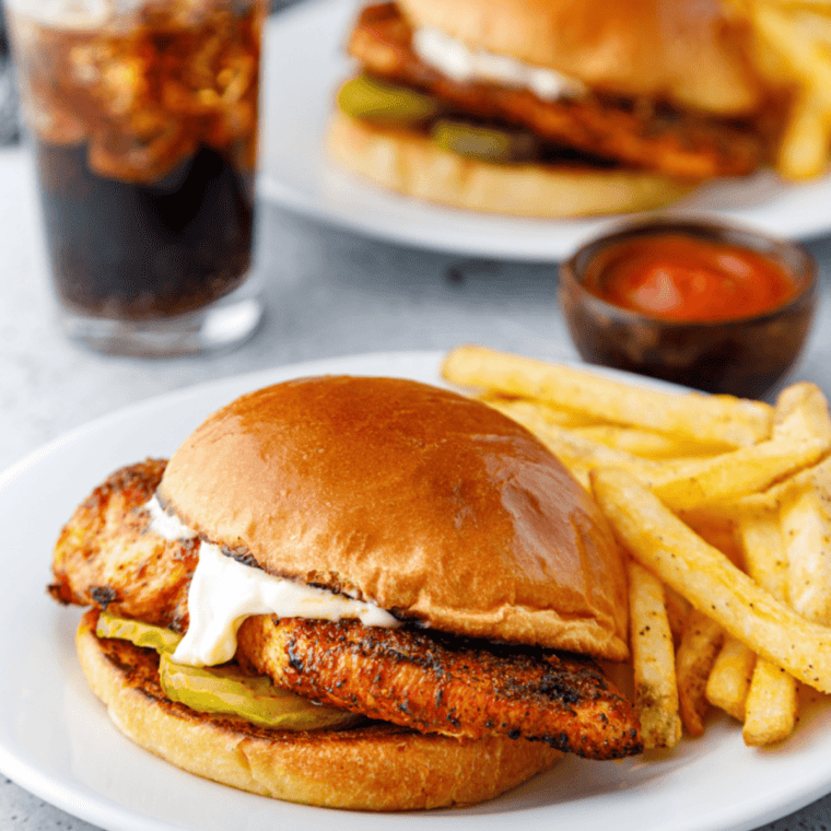 Air Fryer Popeyes Blackened Chicken Sandwich featuring crispy, blackened chicken on a bun with pickles and lettuce.