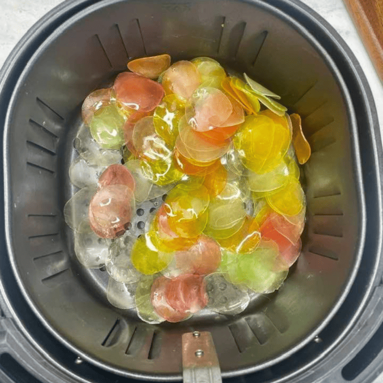 Placing oiled prawn crackers in a single layer in the air fryer basket