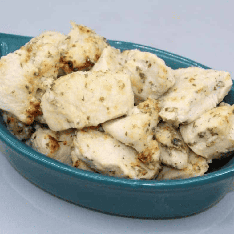Close-up of crispy Air Fryer Ranch Chicken Bites garnished with herbs.