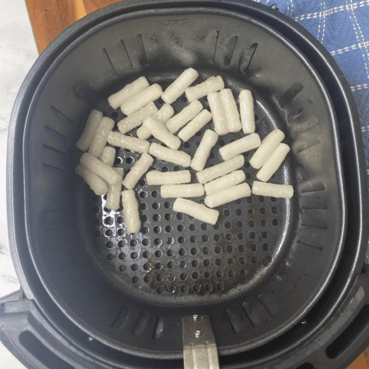 Cooked Rice Cakes in the air fryer basket.