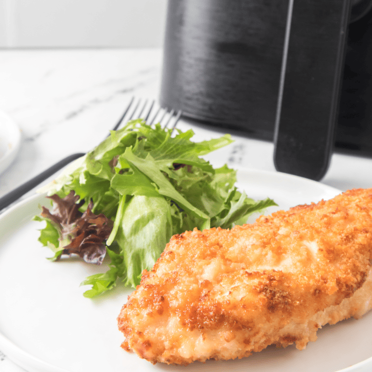 Air Fryer Ritz Cracker Chicken served on a plate, showcasing crispy chicken coated in crushed Ritz crackers, garnished with fresh parsley.